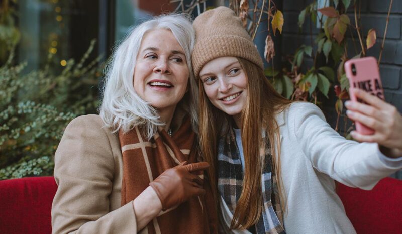 Image of older woman and younger woman taking a selfie
